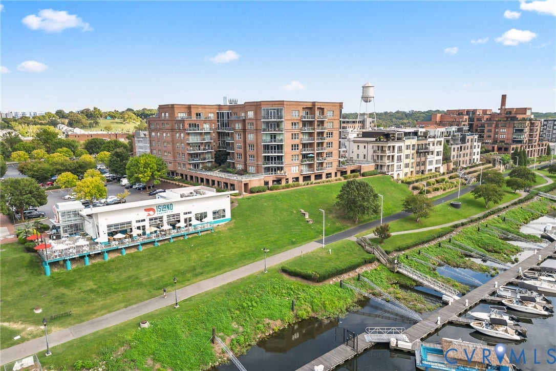 4820 Old Main Street, #503, Sky Line Condo, Richmond, VA 23231 Waterfront development with extensive multi-story brick buildings, a paved walkway, and a marina with multiple boat slips