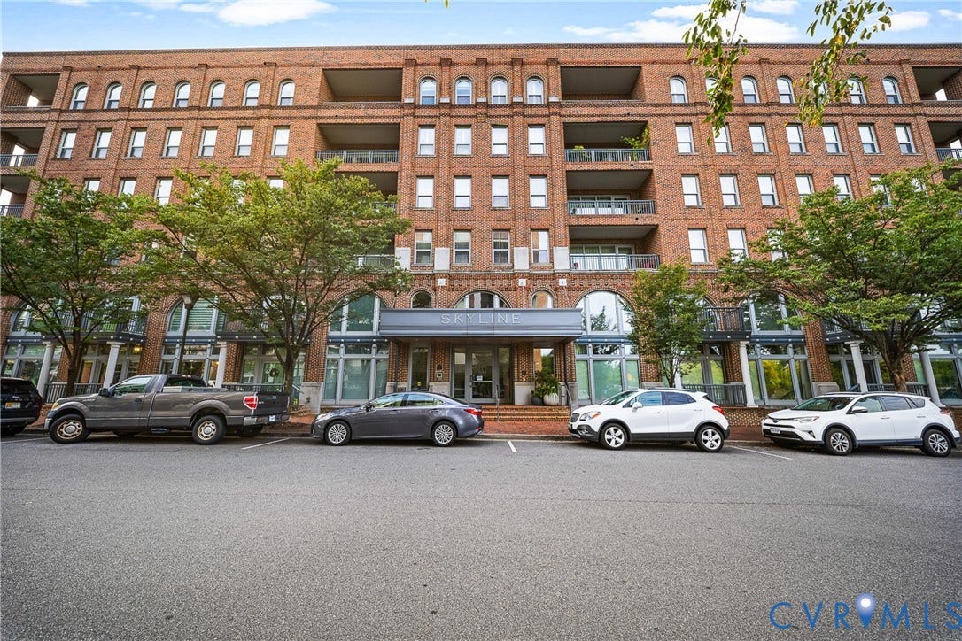 4820 Old Main Street, #503, Sky Line Condo, Richmond, VA 23231 Brick facade featuring multiple balconies and arched windows