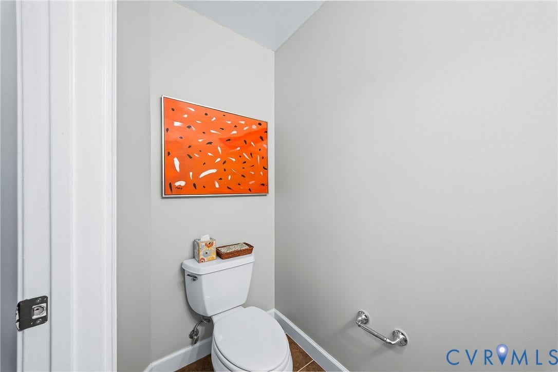 4820 Old Main Street, #503, Sky Line Condo, Richmond, VA 23231 White toilet with a chrome grab bar, wood-finish flooring, and white trim