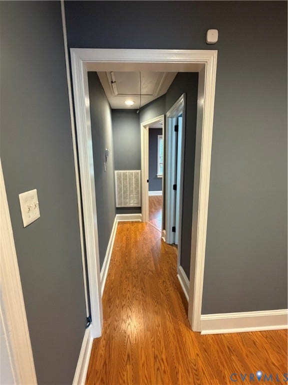 6323 Mallory Drive, Richmond, VA 23226 Hallway featuring wood-finish flooring, white trim, and a ceiling-mounted light fixture