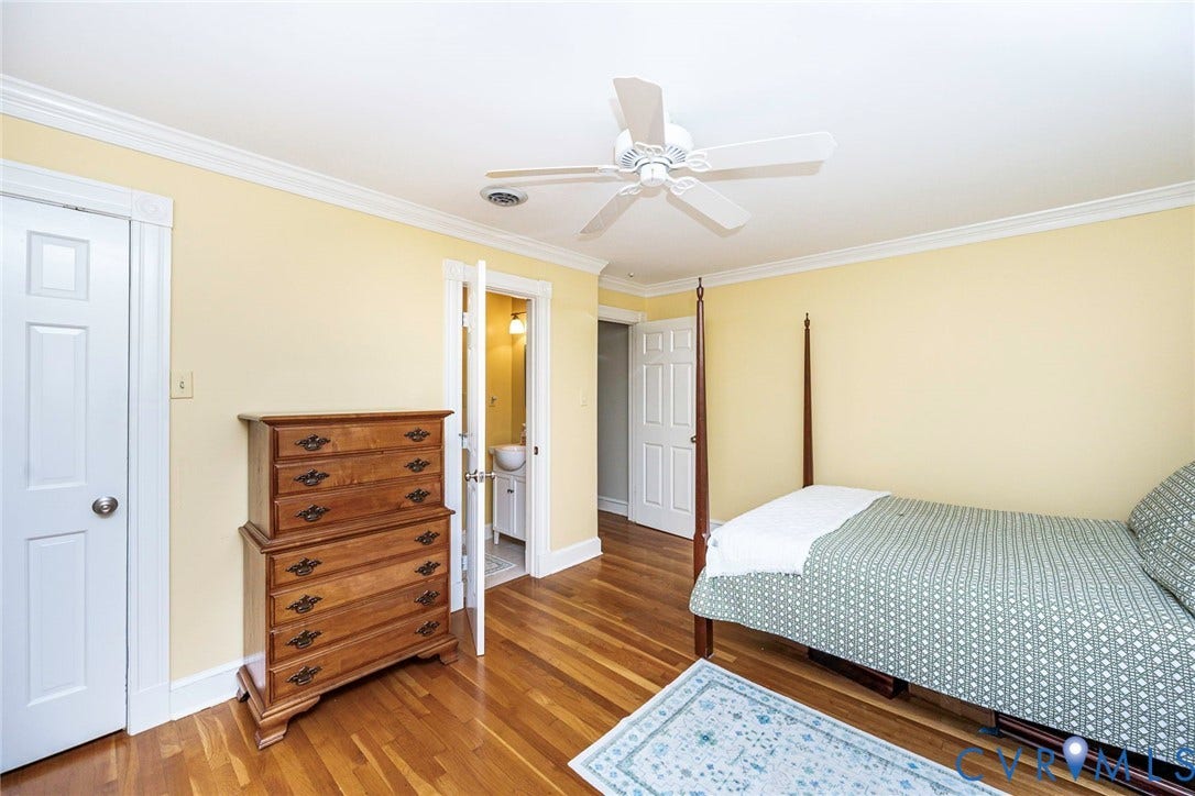 Hardwood flooring, crown molding, ceiling fan, and white trim