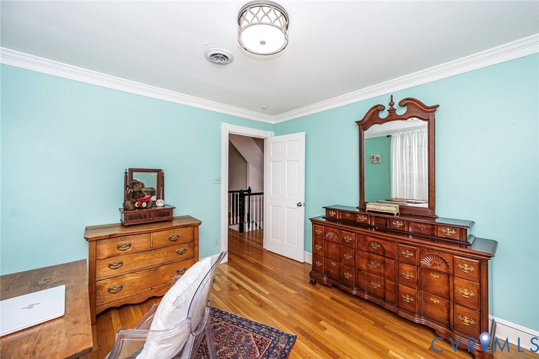Hardwood flooring, crown molding, white trim, recessed lighting, and a flush mount ceiling fixture