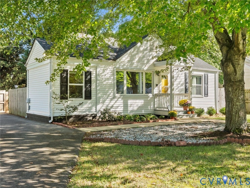 3933 Alma Avenue, Richmond, VA 23222 White siding exterior with a dark shingle roof, paved driveway, and established trees