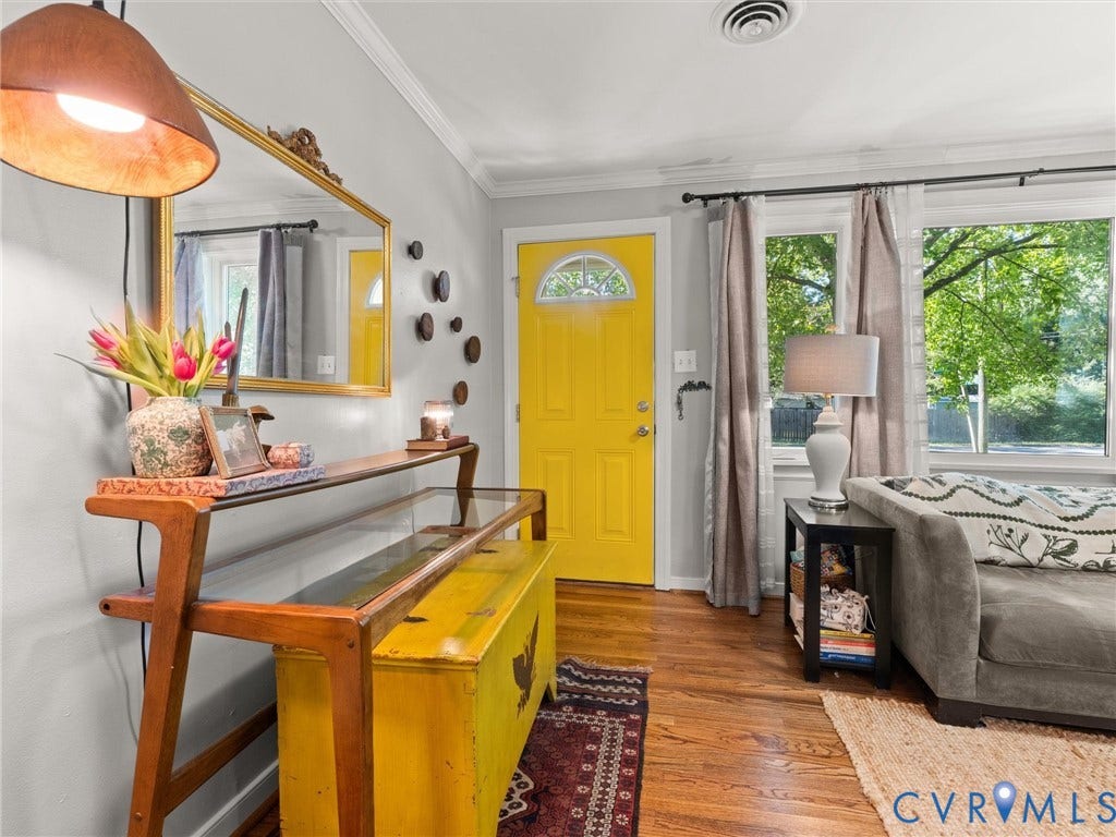 3933 Alma Avenue, Richmond, VA 23222 Hardwood flooring, bright yellow front door with arched glass insert, crown molding, and large window with exterior greenery