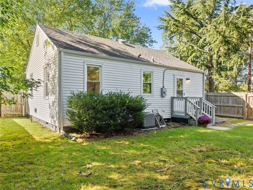 3933 Alma Avenue, Richmond, VA 23222 White siding exterior with a pitched roof, rear wooden deck, and partial privacy fencing
