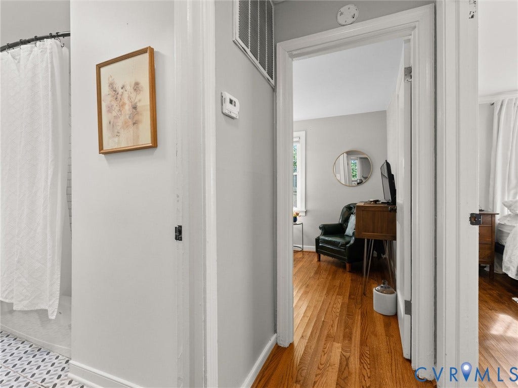 3933 Alma Avenue, Richmond, VA 23222 Hardwood flooring, light gray wall finishes, white trim, and a patterned tile floor in the bathroom