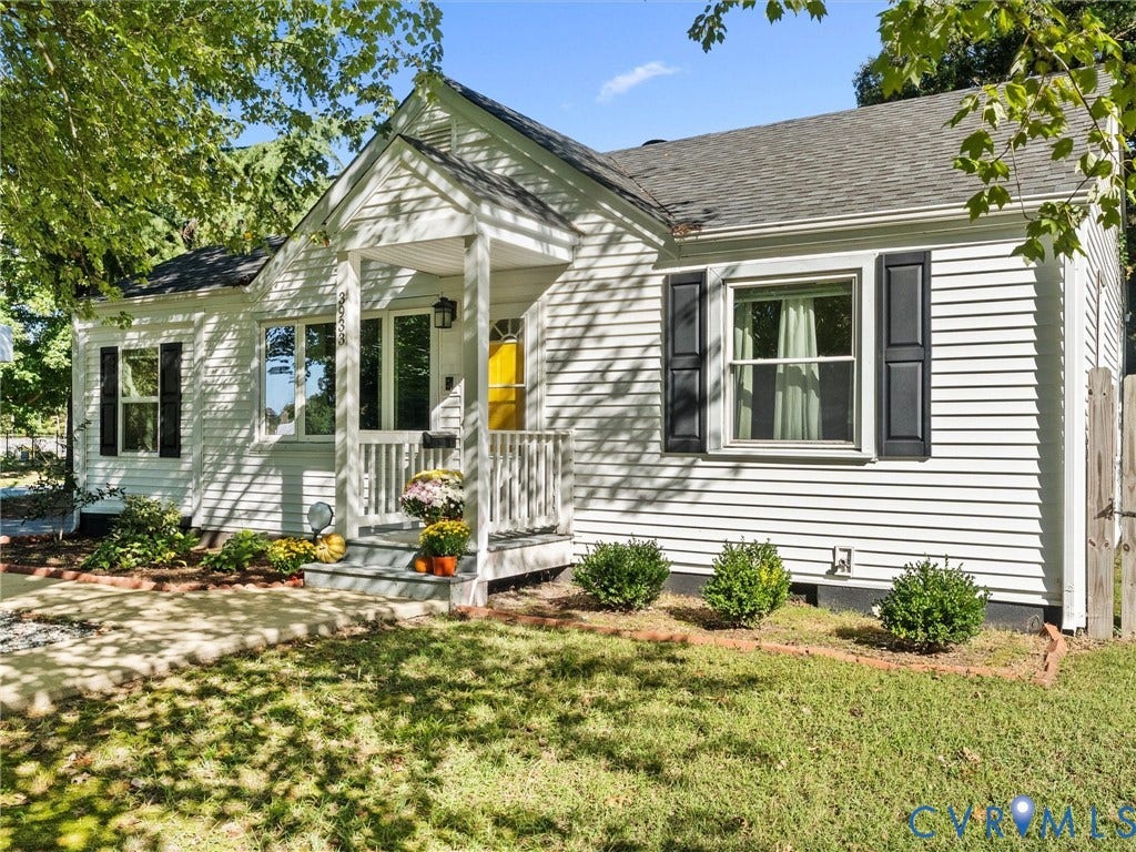 3933 Alma Avenue, Richmond, VA 23222 White siding exterior with a covered front porch, dark shutters, and a yellow front door