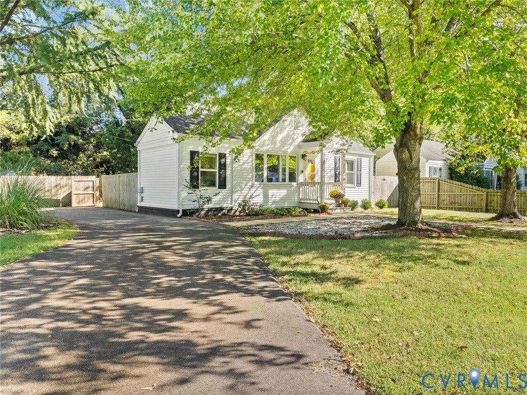 3933 Alma Avenue, Richmond, VA 23222 White siding exterior with black shutters, covered front porch, and a paved driveway