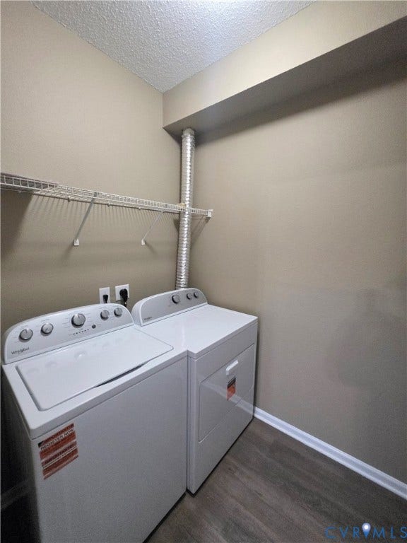 Laundry area with light-toned walls and wood-finish flooring