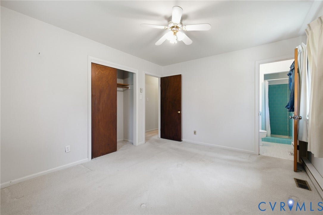 10215 River Road, South Chesterfield, VA 23803 Light-toned carpeting, ceiling fan, and a wood-finish interior door