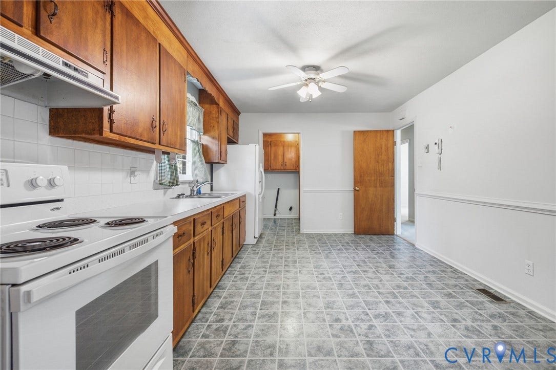 10215 River Road, South Chesterfield, VA 23803 Kitchen featuring wood cabinetry, white appliances, white tile backsplash, white countertops, and patterned floor tile