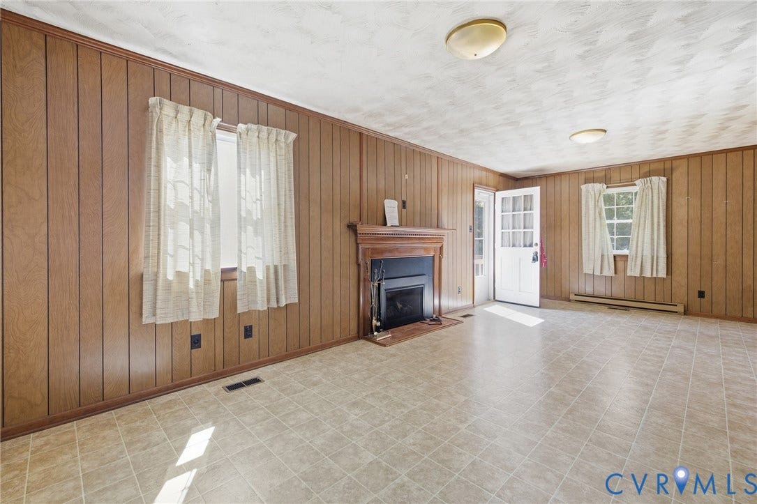 10215 River Road, South Chesterfield, VA 23803 Wood-paneled walls featuring multiple windows