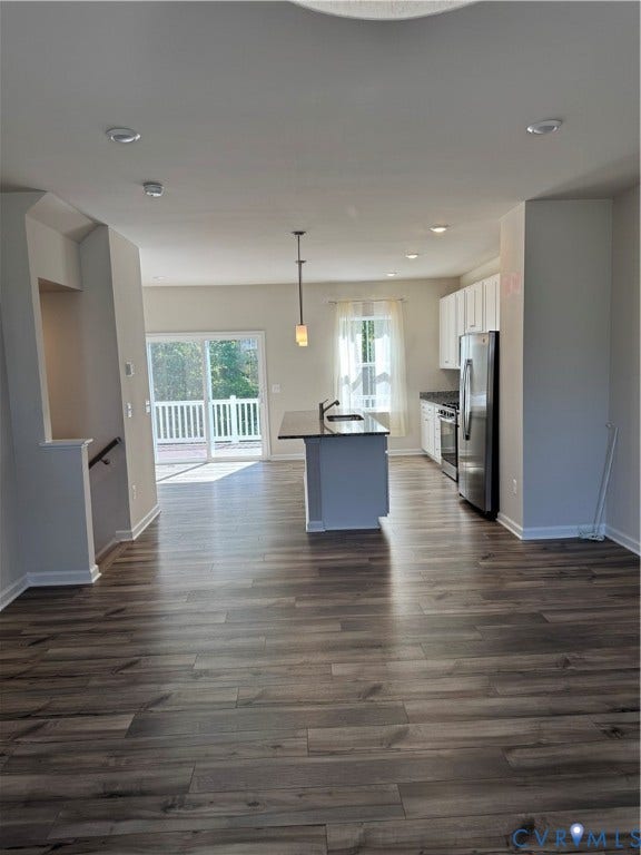 16025 Abelson Way, Chesterfield, VA 23832 Open-concept living area featuring wood-finish flooring, recessed lighting, and a kitchen island with a sink.