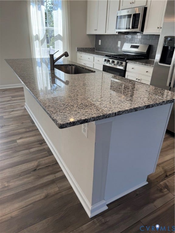 16025 Abelson Way, Chesterfield, VA 23832 Kitchen island with a stainless steel. undermount sink and a dark-finish faucet