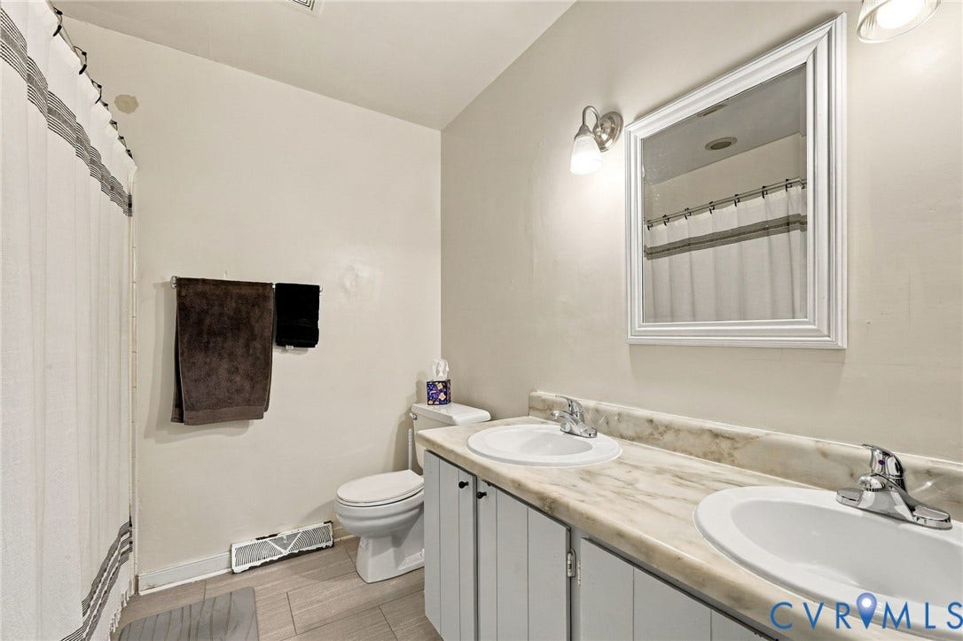 12308 Poplar Forest Drive, Tuckahoe Village, Henrico, VA 23238 Dual sinks with chrome fixtures, a framed mirror, and vanity lighting