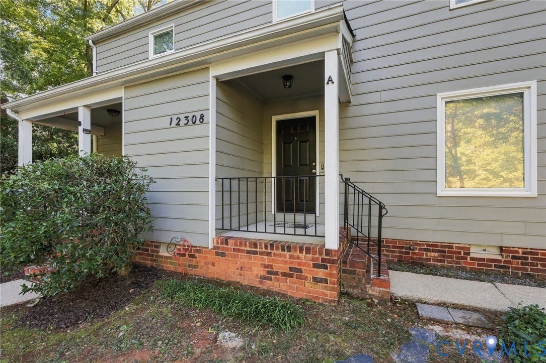 12308 Poplar Forest Drive, Tuckahoe Village, Henrico, VA 23238 Exterior featuring horizontal siding, a covered porch with white columns, brick foundation, and a black entry door with an iron railing