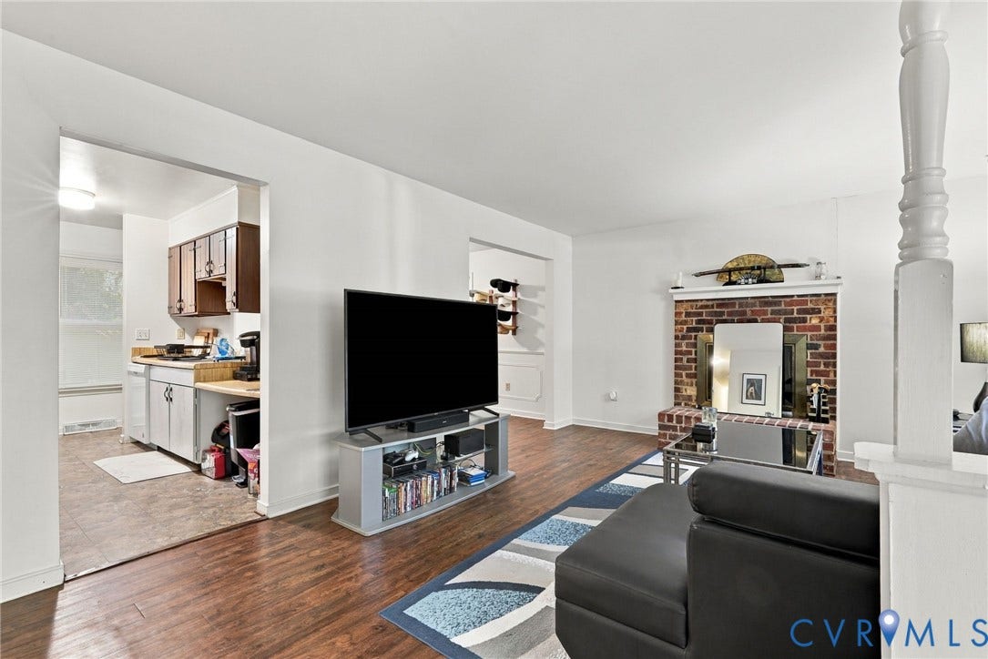 12308 Poplar Forest Drive, Tuckahoe Village, Henrico, VA 23238 Wood-finish flooring, white painted walls, and a brick-surround fireplace