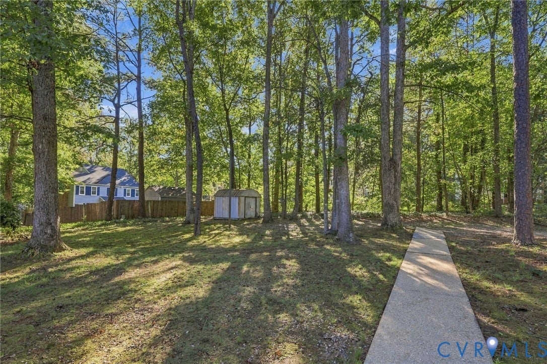 12308 Poplar Forest Drive, Tuckahoe Village, Henrico, VA 23238 Expansive yard featuring a concrete pathway, mature trees, and a storage shed