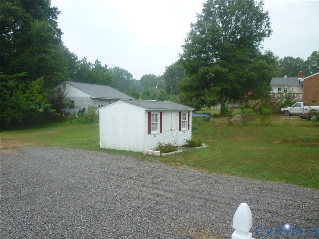 1645 Manakin Road, Manakin, VA 23103 Gravel driveway leading to a white storage shed with red shutters