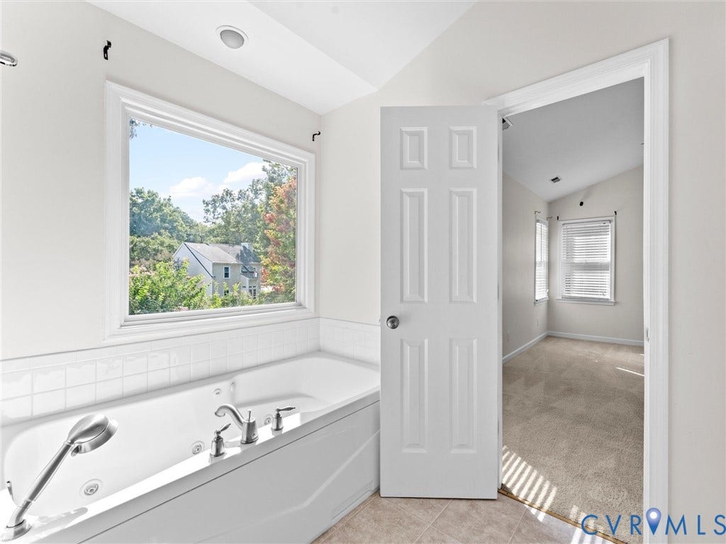 Soaking tub with integrated jets and handheld shower
