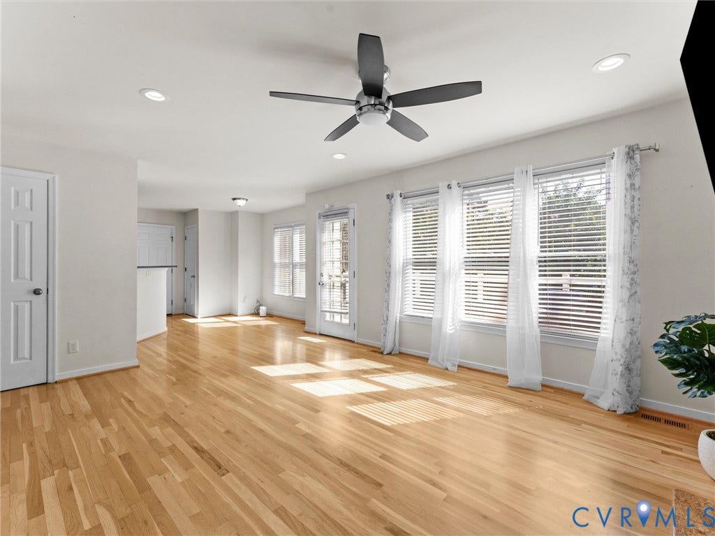 Hardwood flooring, recessed lighting, ceiling fan, white paneled doors, multiple windows