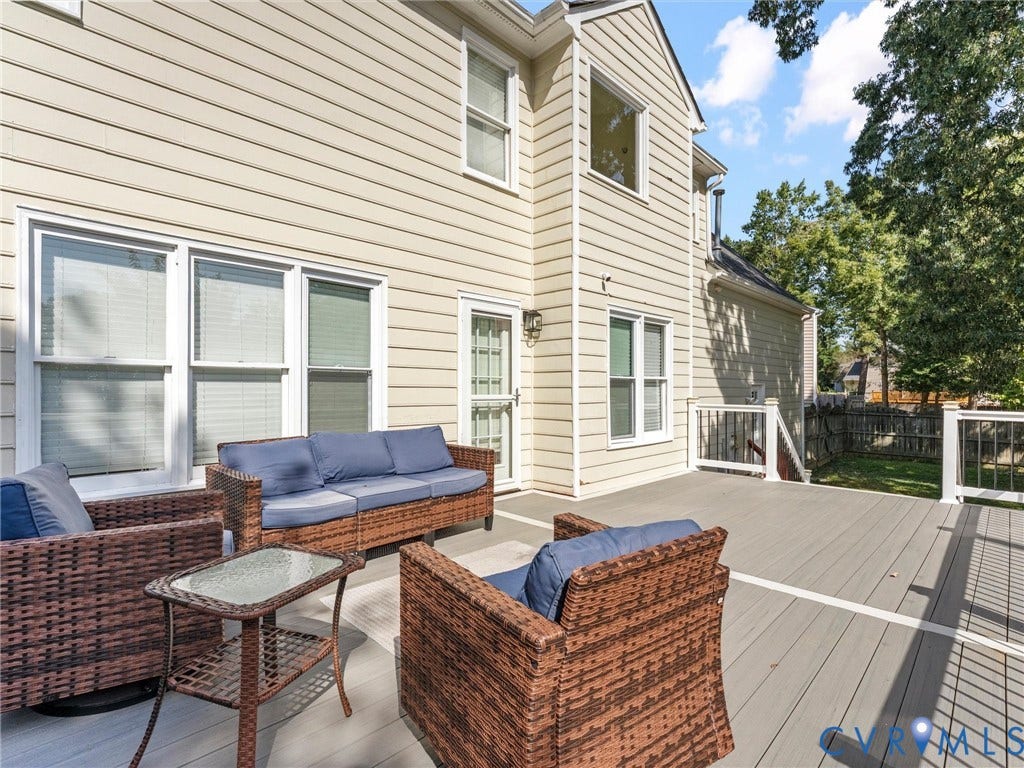 Expansive outdoor deck with gray composite decking, white railings, and black balusters