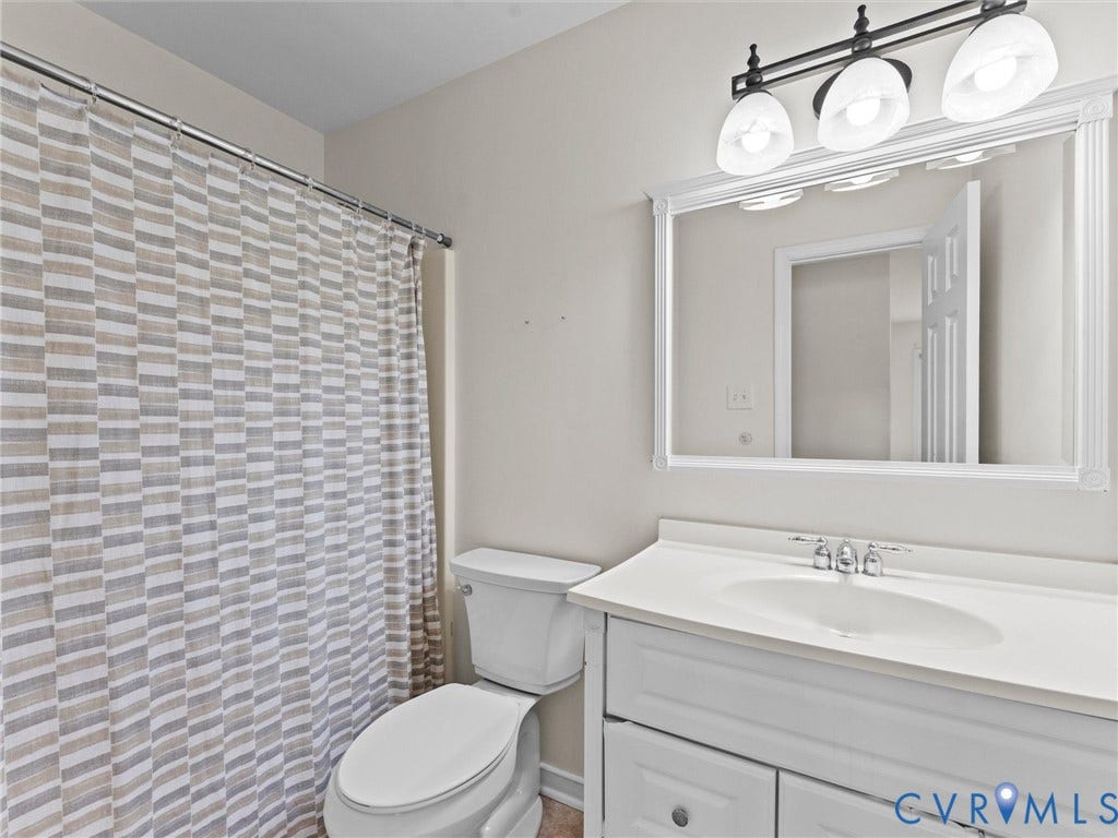 White vanity with integrated sink, chrome faucet, and framed mirror