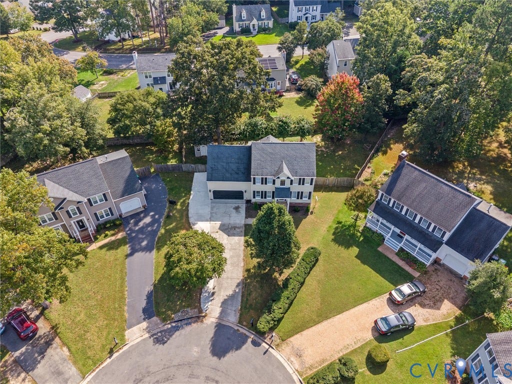 Two-story residence with a gray shingle roof, attached garage, and a concrete driveway