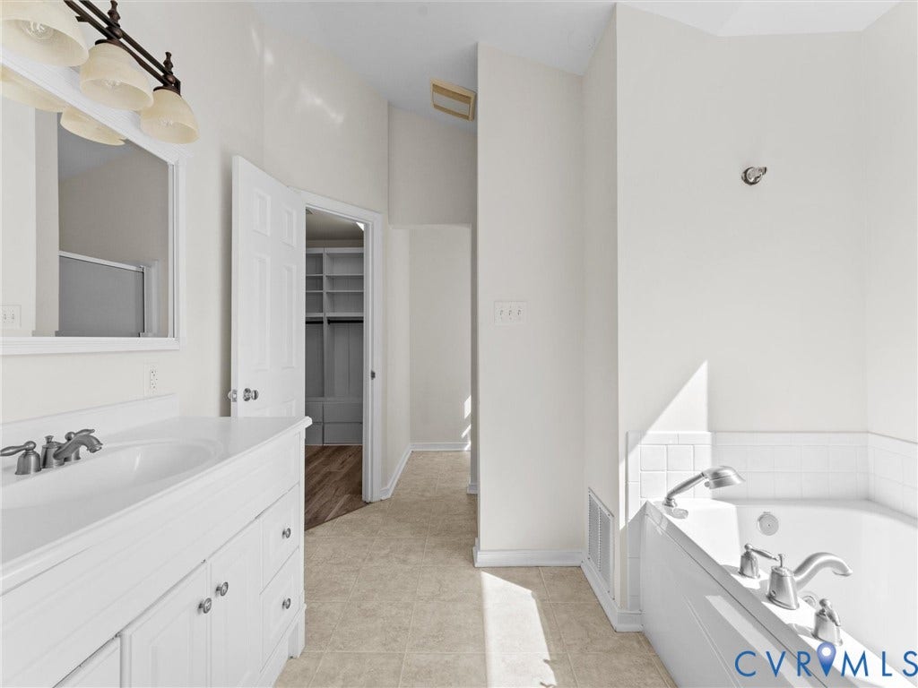 White vanity with chrome fixtures and integrated sink