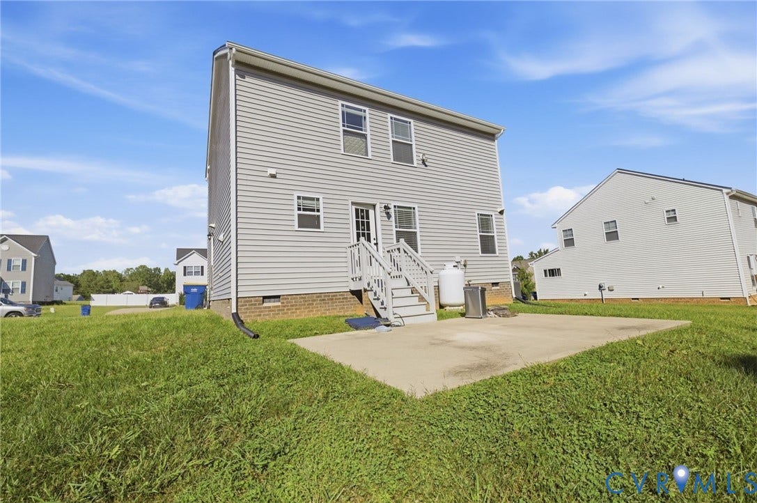 Gray siding exterior with a concrete patio