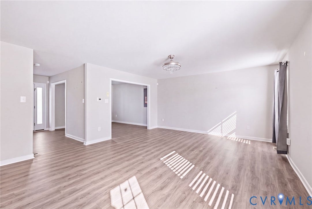 Wood-finish flooring, recessed lighting, and a semi-flush mount fixture