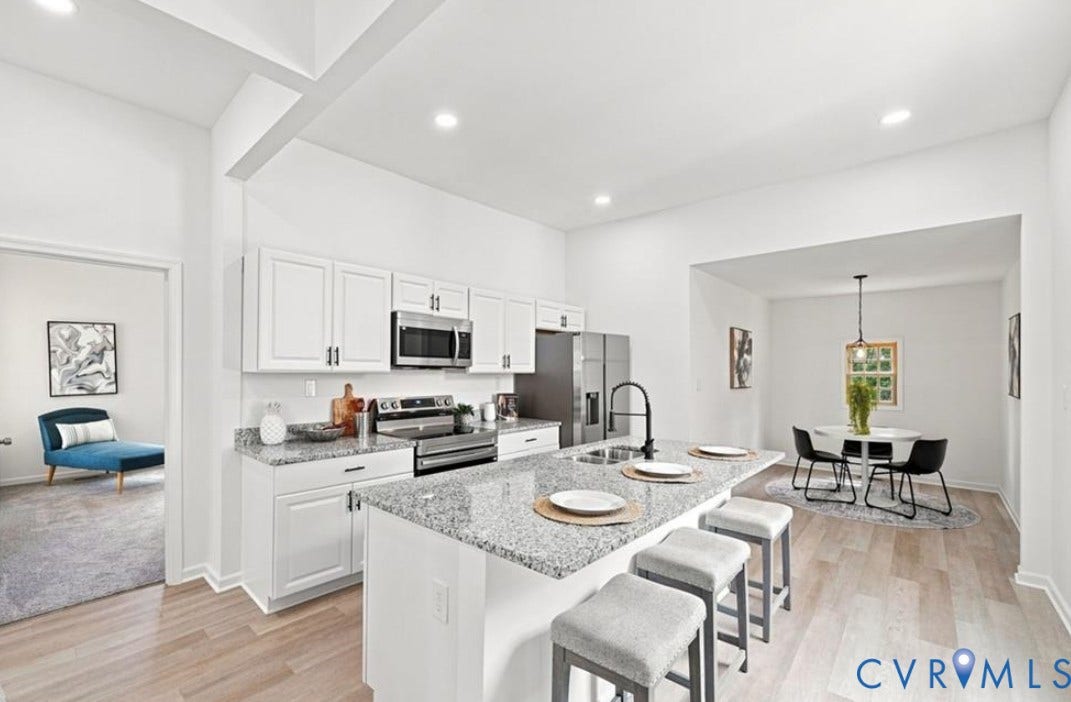 104 E Fillmore Street, Petersburg, VA 23803 Well-appointed kitchen featuring granite countertops, stainless steel appliances, white cabinetry, and wood-finish flooring