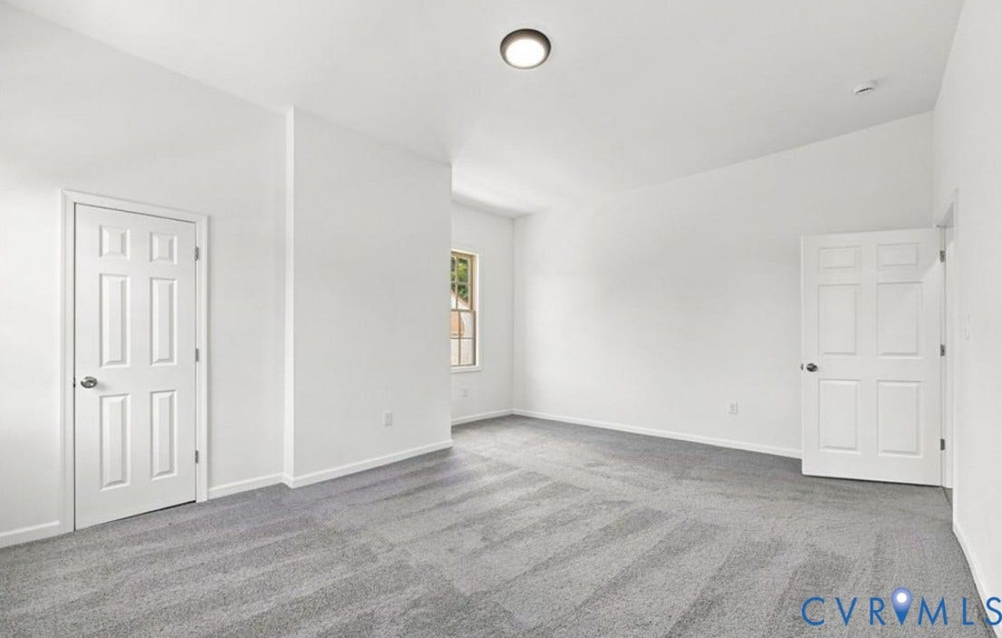 104 E Fillmore Street, Petersburg, VA 23803 Spacious room featuring neutral white walls, recessed ceiling lighting, and gray patterned carpet flooring