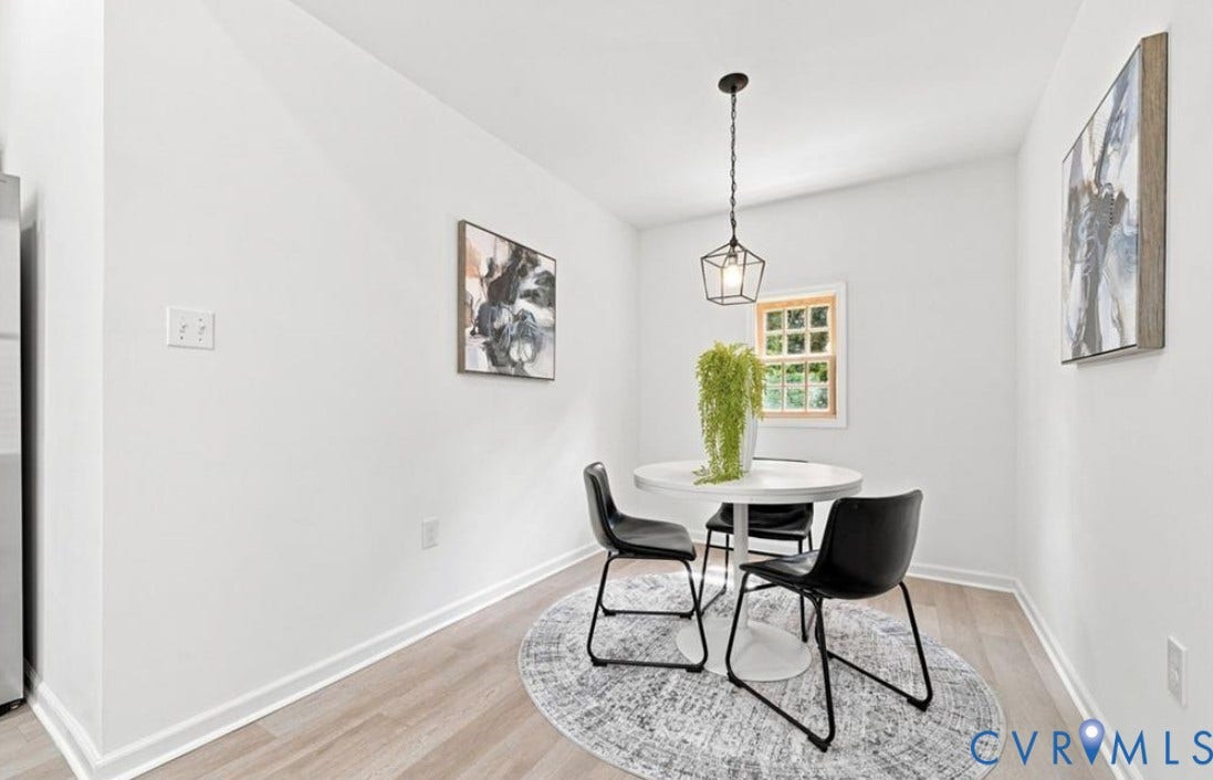 104 E Fillmore Street, Petersburg, VA 23803 Recessed window with wood trim, wood-finish flooring, and a contemporary geometric pendant light fixture