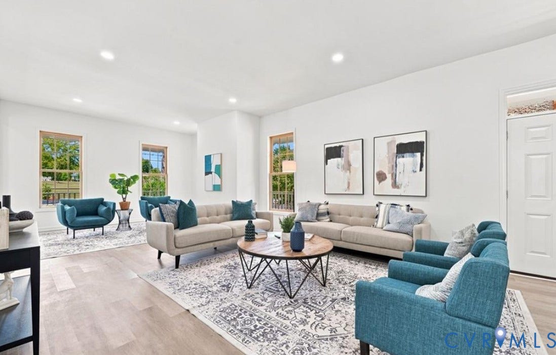 104 E Fillmore Street, Petersburg, VA 23803 Spacious open-concept living area featuring multiple seating zones with recessed ceiling lighting, wood-finish flooring throughout, and large windows providing natural light