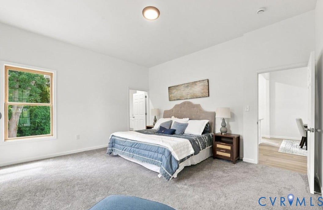 104 E Fillmore Street, Petersburg, VA 23803 Expansive bedroom with light-toned carpeting and abundant natural light from a large window