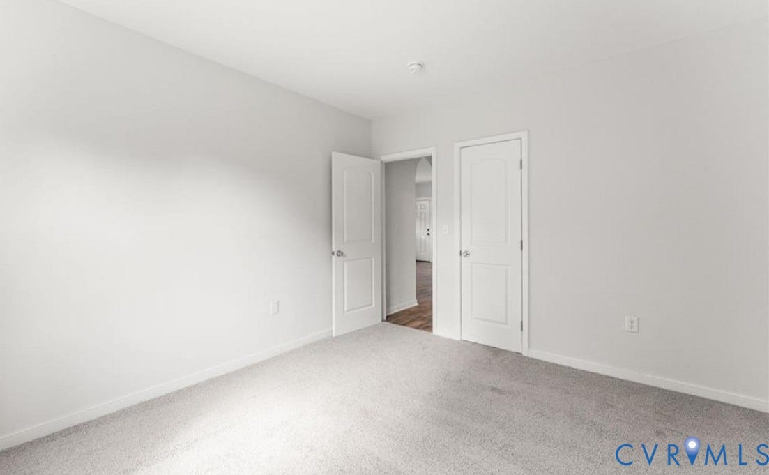 222 Elm Street, Petersburg, VA 23803 Bright secondary bedroom with neutral wall finishes, carpeted flooring, and dual closet storage featuring white six-panel doors
