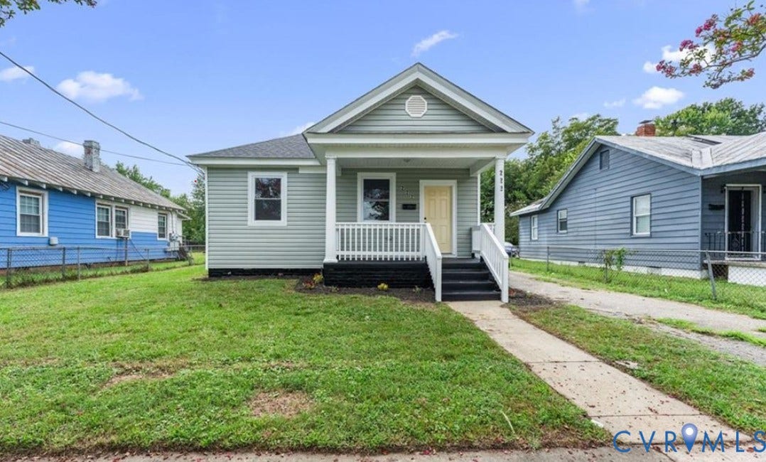 222 Elm Street, Petersburg, VA 23803 Light gray siding exterior with a covered front porch featuring white railings