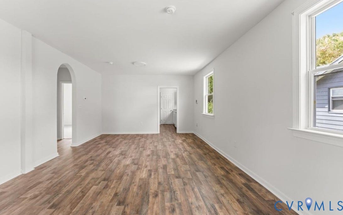 222 Elm Street, Petersburg, VA 23803 Wood-finish flooring, white walls, multiple windows, and an arched doorway