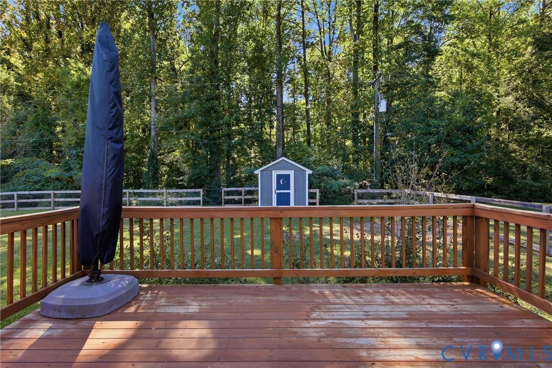 Expansive wood deck with natural finish, featuring a wood railing