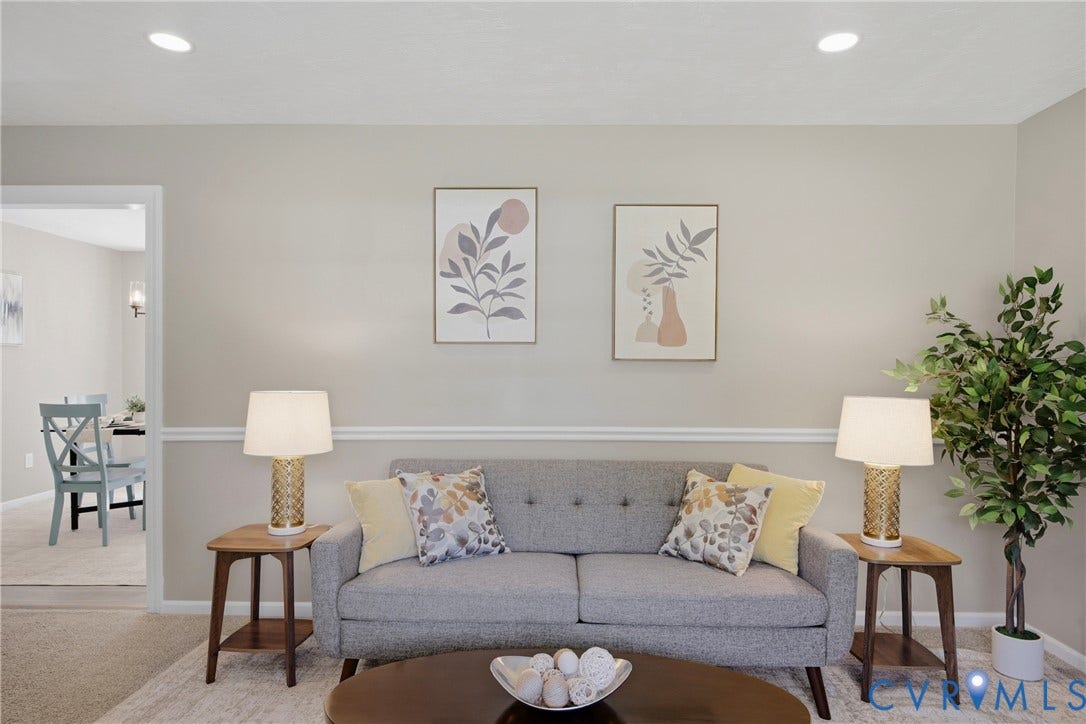Recessed ceiling lighting, crown molding, wall paneling, and wood-finish side tables