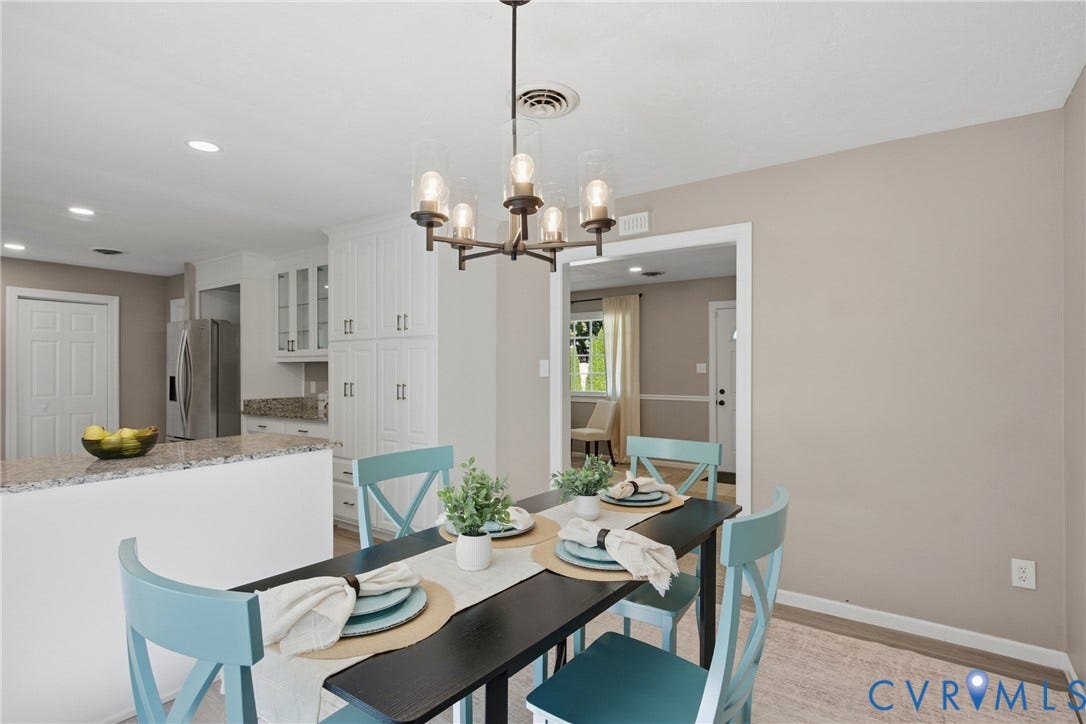 Open concept dining area with a contemporary chandelier, recessed lighting, and light-toned wall paint