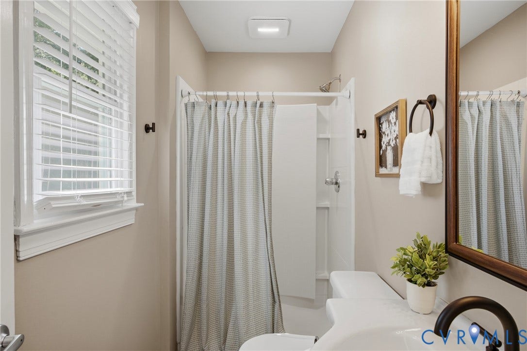 White vanity with an integrated sink and a dark bronze faucet
