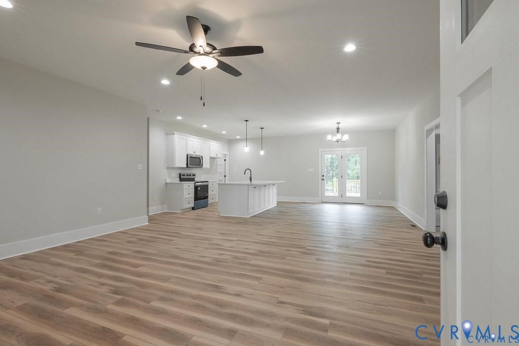 5301 Chimney Springs Drive, Goochland, VA 23063 Open-concept living area featuring wood-finish flooring throughout, recessed ceiling lighting, and a ceiling fan with integrated light fixture