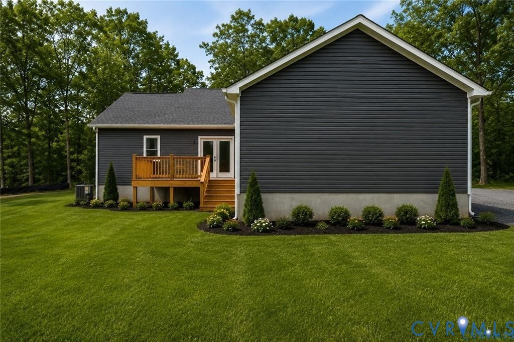 5301 Chimney Springs Drive, Goochland, VA 23063 Charcoal gray siding exterior with white trim, wood deck with stairs, double glass panel doors, and manicured landscaping