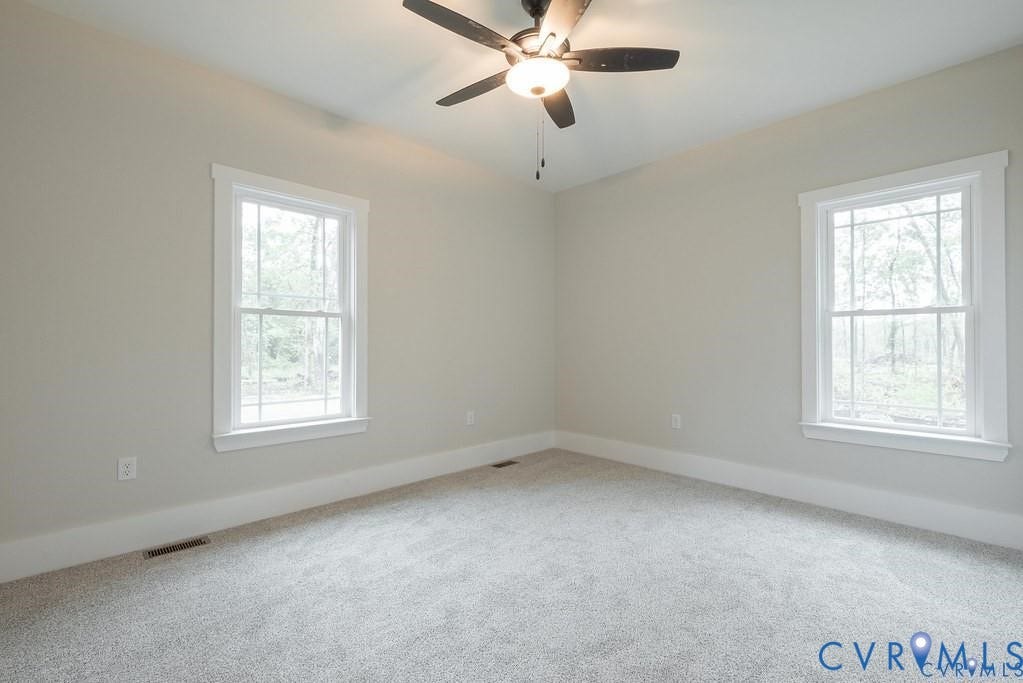 5301 Chimney Springs Drive, Goochland, VA 23063 Recessed lighting, ceiling fan light fixture, two double-hung windows, light-colored carpeting, and neutral wall paint