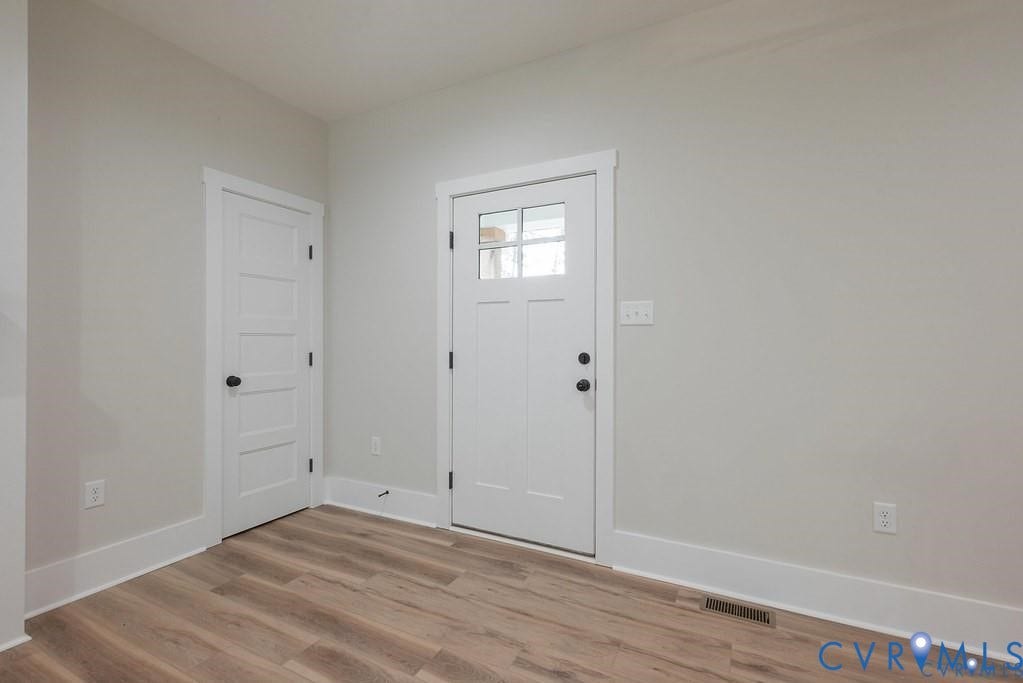 5301 Chimney Springs Drive, Goochland, VA 23063 Entry area featuring wood-finish flooring, light gray walls, and white trim