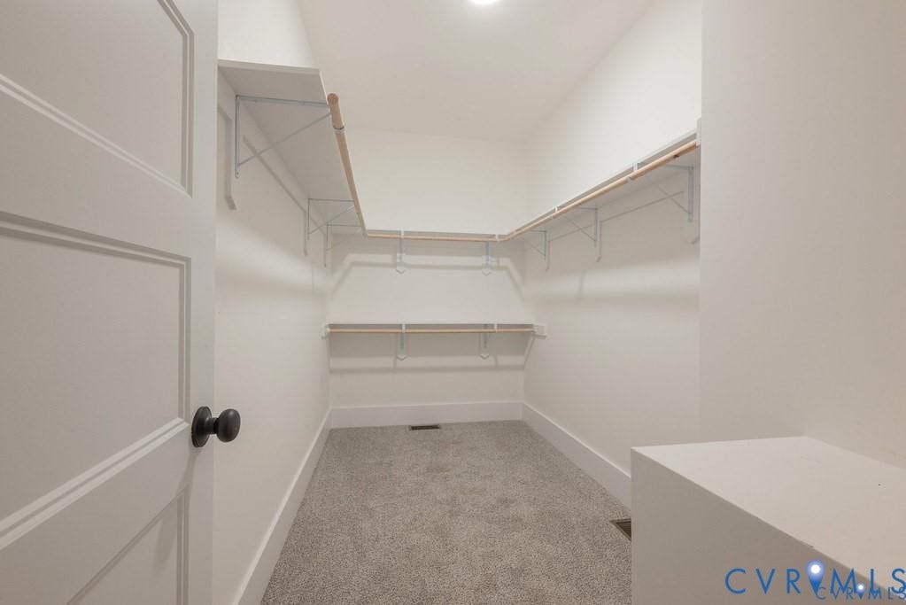 5301 Chimney Springs Drive, Goochland, VA 23063 Walk-in closet featuring built-in shelving, hanging rods, recessed lighting, and carpeting