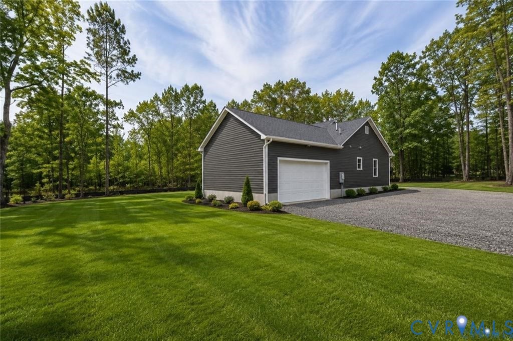 5301 Chimney Springs Drive, Goochland, VA 23063 Detached structure with dark gray siding, white garage door, gravel driveway, and mature landscaping