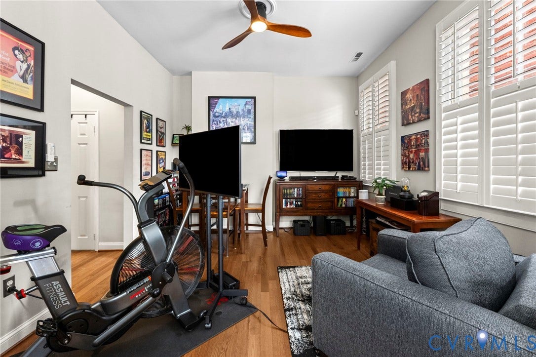 Hardwood flooring throughout, with a ceiling fan and recessed lighting